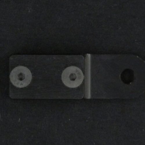 Metal latch with screws on black surface for QRC Karts safety lock.